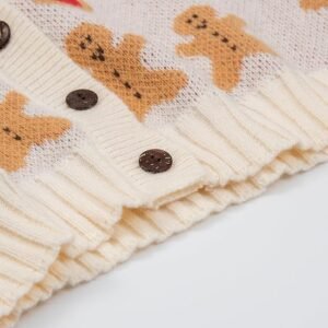  Detail of soft knit fabric, decorative buttons, and unique playful pattern on a cozy winter cardigan.