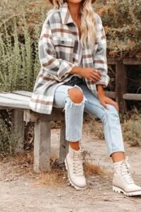 A Beaully flannel shacket styled as a layered outfit with jeans and ankle boots for autumn.